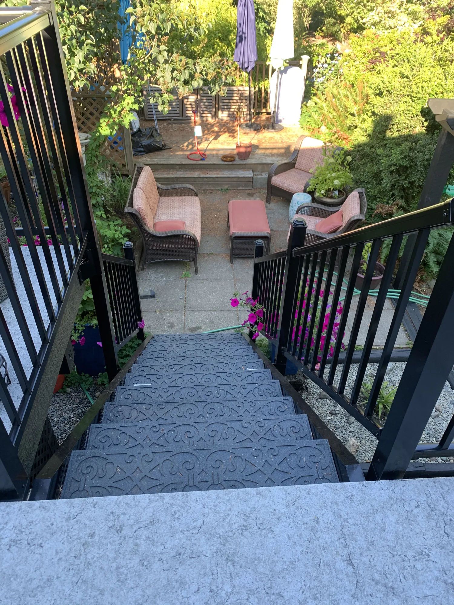 Grey deck walkway with black railings